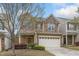 Charming two-story home with a two car garage, stone accents, and manicured lawn at 140 Torrey Heights Ln, Durham, NC 27703