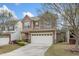 Charming two-story home with a two car garage, stone accents, and manicured lawn at 140 Torrey Heights Ln, Durham, NC 27703