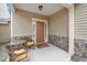 Inviting front porch with seating area and stylish front door at 140 Torrey Heights Ln, Durham, NC 27703