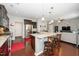 Spacious kitchen with a granite island, stainless steel appliances, and bar stool seating at 140 Torrey Heights Ln, Durham, NC 27703