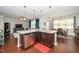 Open kitchen with a center island, stainless steel appliances, granite countertops, and dark wood cabinets at 140 Torrey Heights Ln, Durham, NC 27703