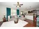 Open-concept living room with a comfortable sofa, large windows, and ceiling fan at 140 Torrey Heights Ln, Durham, NC 27703