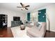 Comfortable living room with a sectional sofa, plush rug, and modern entertainment center at 140 Torrey Heights Ln, Durham, NC 27703