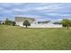Large, grassy backyard enclosed by a white fence, offering privacy and space at 1454 Spring Pond Rd, Nashville, NC 27856