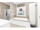 Bathroom with tiled floors, a stained glass window, and bathtub with white cabinets at 1454 Spring Pond Rd, Nashville, NC 27856