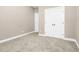 Bedroom showcasing neutral carpet, base trim, and double door closet for ample storage space at 1454 Spring Pond Rd, Nashville, NC 27856