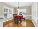 Bright breakfast nook with hardwood flooring, windows, and decorative lighting at 1454 Spring Pond Rd, Nashville, NC 27856