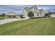 Charming home featuring a large manicured lawn, attached garage, and separate carport at 1454 Spring Pond Rd, Nashville, NC 27856