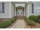 Welcoming front entrance with a decorative glass door and elegant sidelights at 1454 Spring Pond Rd, Nashville, NC 27856
