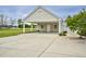 Detached garage with white columns, beige siding, and an oversized driveway at 1454 Spring Pond Rd, Nashville, NC 27856