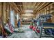Spacious garage featuring exposed wooden beams, concrete floors, and ample storage space at 1454 Spring Pond Rd, Nashville, NC 27856