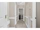 Hallway with neutral paint, carpet flooring, white trim, and access to various rooms at 1454 Spring Pond Rd, Nashville, NC 27856
