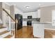 Modern kitchen featuring white cabinets, black appliances, and a stylish backsplash at 1454 Spring Pond Rd, Nashville, NC 27856