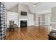 Cozy living room with a fireplace, built-in shelving, and hardwood flooring at 1454 Spring Pond Rd, Nashville, NC 27856