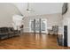 Bright living room featuring hardwood floors, fireplace, and French doors to the back at 1454 Spring Pond Rd, Nashville, NC 27856