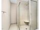 Modern shower featuring tile surround, a small built-in seat, and a sleek glass door at 1454 Spring Pond Rd, Nashville, NC 27856