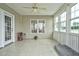 Bright sunroom with tiled floor, multiple windows, and neutral decor at 1454 Spring Pond Rd, Nashville, NC 27856