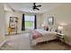 Bright bedroom features a cozy bed, a ceiling fan, and a small desk area at 1521 Providence Glen Dr # 1521, Chapel Hill, NC 27514