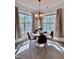 Sunlit dining area showcases a modern chandelier and expansive windows with sheer drapes at 1521 Providence Glen Dr # 1521, Chapel Hill, NC 27514