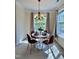 Light-filled dining area boasts a stylish chandelier and large windows for sunny meals at 1521 Providence Glen Dr # 1521, Chapel Hill, NC 27514