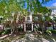 Charming brick condo building exterior with lush green trees and well-maintained landscaping at 1521 Providence Glen Dr # 1521, Chapel Hill, NC 27514