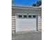 A white garage door with windows near the top, with shingle style siding on the exterior at 1521 Providence Glen Dr # 1521, Chapel Hill, NC 27514