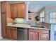 Bright kitchen featuring granite countertops, stainless steel dishwasher, and wood cabinets at 1521 Providence Glen Dr # 1521, Chapel Hill, NC 27514