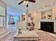 Bright living room showcasing a fireplace, ceiling fan, and an open view of the dining area at 1521 Providence Glen Dr # 1521, Chapel Hill, NC 27514