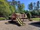 Fun community playground with slides and play area surrounded by mature trees at 1521 Providence Glen Dr # 1521, Chapel Hill, NC 27514