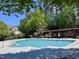 Enjoy a refreshing swim in the community pool, surrounded by lush greenery and a pergola at 1521 Providence Glen Dr # 1521, Chapel Hill, NC 27514
