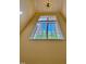 Bright window with geometric ceiling lamp offering a view of a tree and clear blue skies at 1521 Providence Glen Dr # 1521, Chapel Hill, NC 27514