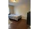 Cozy bedroom with hardwood floors, a bed, and a black dresser creating a relaxing and inviting space at 158 Randolph Dr, Clayton, NC 27520