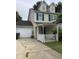 Inviting two-story home featuring a covered front porch, attached garage, and well-maintained yard at 158 Randolph Dr, Clayton, NC 27520