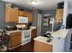 Well-lit kitchen featuring modern appliances, ample counter space, and wood-look floors at 158 Randolph Dr, Clayton, NC 27520