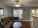 Comfortable living room with ample seating, a ceiling fan, and a view to the outside at 158 Randolph Dr, Clayton, NC 27520
