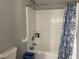 Clean white shower with blue patterned shower curtain, includes convenient soap and shampoo storage at 158 Randolph Dr, Clayton, NC 27520
