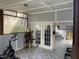 Enclosed sunroom with lattice windows, exercise equipment, and a cat tree, offering a versatile living area at 158 Randolph Dr, Clayton, NC 27520