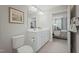 Clean bathroom featuring double sink vanity with white cabinets and a view to the bedroom at 16 Saintsbury Dr, Fuquay Varina, NC 27526