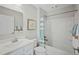 Bright bathroom featuring a vanity, toilet, and a bathtub with a shower, perfect for relaxation at 16 Saintsbury Dr, Fuquay Varina, NC 27526