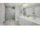 Modern bathroom with tiled walk-in shower, double sink vanity, and ample lighting at 16 Saintsbury Dr, Fuquay Varina, NC 27526