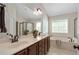 Bright bathroom boasts double sinks, a soaking tub, and large windows for natural light and relaxation at 1602 Eagle Lodge Ln, Durham, NC 27703
