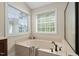 Bright bathroom features a luxurious soaking tub with large window, perfect for relaxing at 1602 Eagle Lodge Ln, Durham, NC 27703