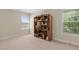 Bright bedroom with large bookcase, neutral walls, and two large windows for natural light at 1602 Eagle Lodge Ln, Durham, NC 27703