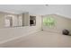 Versatile bonus room featuring neutral carpet, TV and expansive window, ideal for entertaining and activities at 1602 Eagle Lodge Ln, Durham, NC 27703