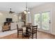 Cozy dining area next to a fireplace, with view to the living room and exterior access at 1602 Eagle Lodge Ln, Durham, NC 27703