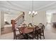 Traditional dining room with a wood table, upholstered chairs, and elegant chandelier at 1602 Eagle Lodge Ln, Durham, NC 27703