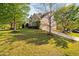 Charming home featuring a manicured lawn, two-car garage, and a stone and siding facade at 1602 Eagle Lodge Ln, Durham, NC 27703