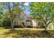 Beautifully landscaped two-story brick home with mature trees and a well-maintained lawn at 1602 Eagle Lodge Ln, Durham, NC 27703
