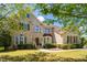 Charming two-story brick home featuring a lush front yard and inviting front entrance at 1602 Eagle Lodge Ln, Durham, NC 27703