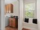 Convenient laundry area with built-in cabinets, sink, and a bright window with a window seat at 1602 Eagle Lodge Ln, Durham, NC 27703